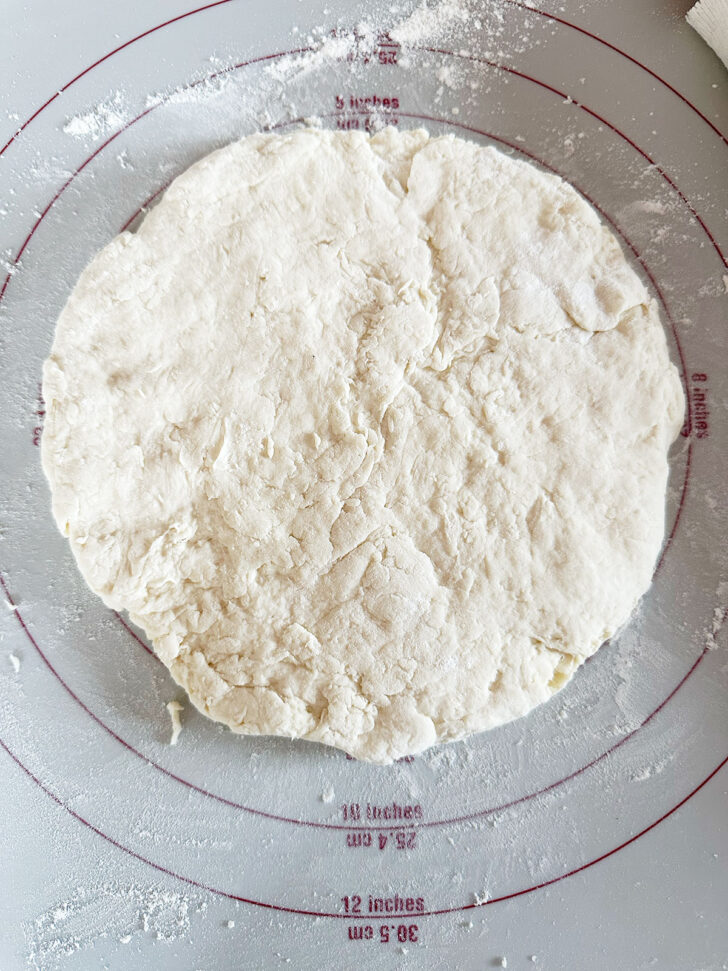 Dough patted out into a circle.