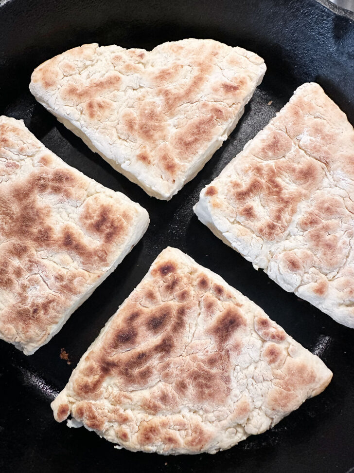 Soda farls after flipping in the skillet.