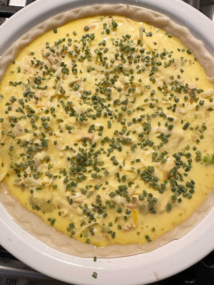Chives scattered on top of quiche.