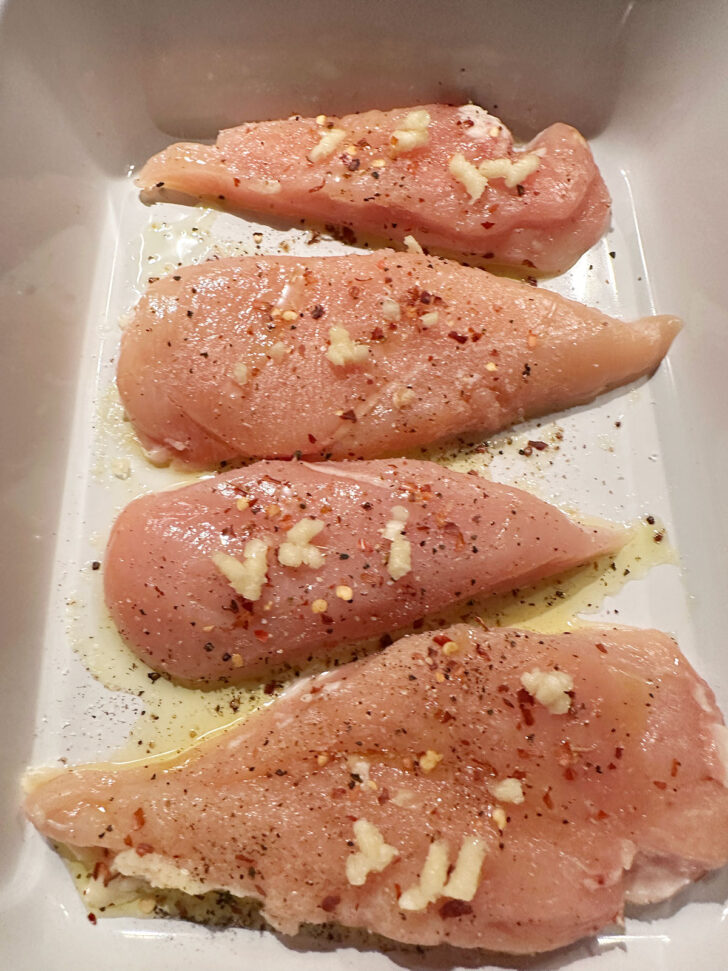 Chicken breasts in baking dish.