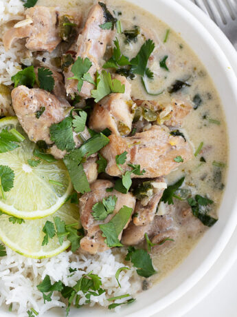Creamy coconut lime chicken in a bowl over rice.
