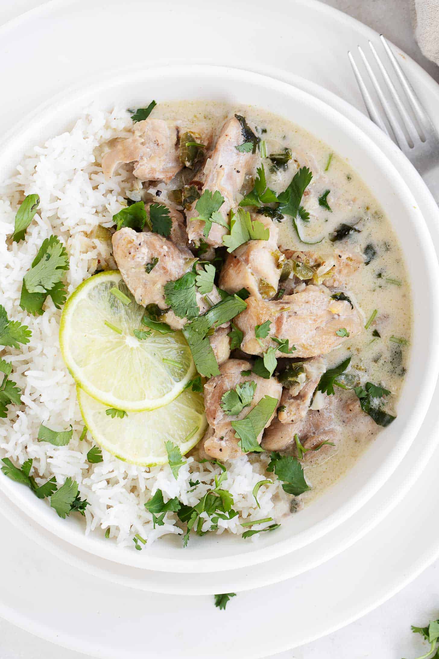 Coconut lime chicken in bowl with rice.