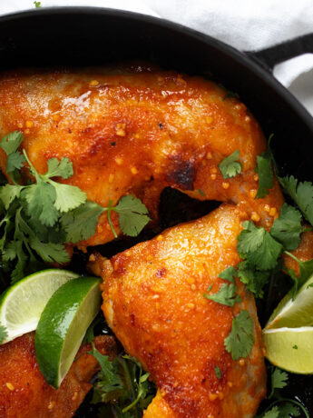 Sriracha chicken legs in baking dish.