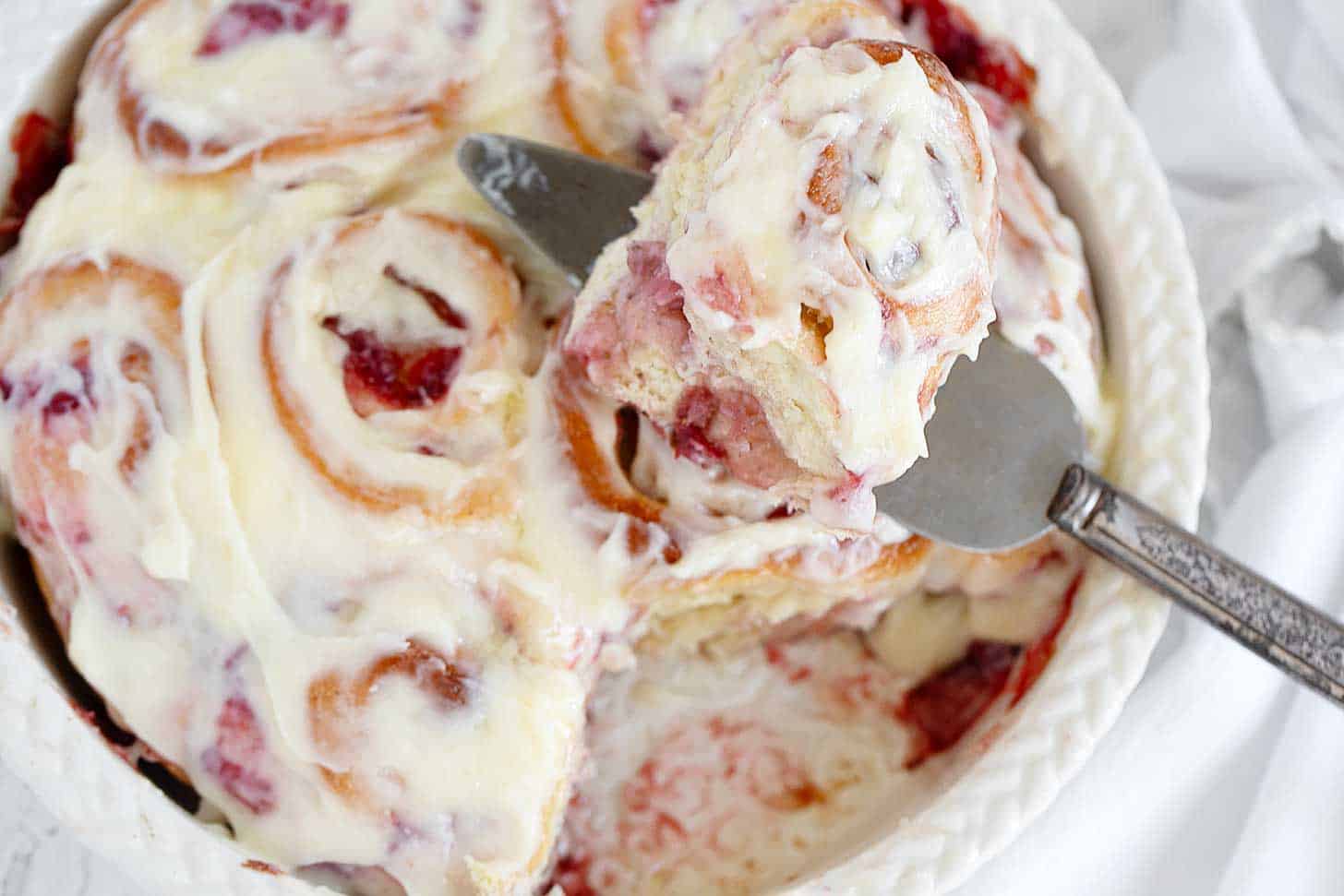 Strawberry cinnamon rolls in baking dish.