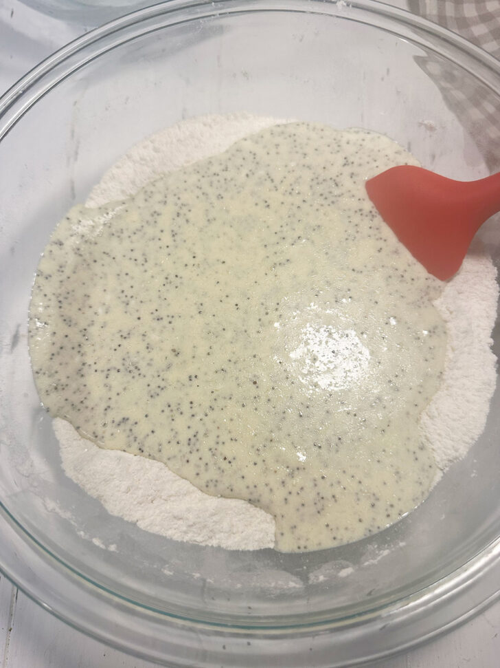 Adding the wet ingredients to the dry ingredients.