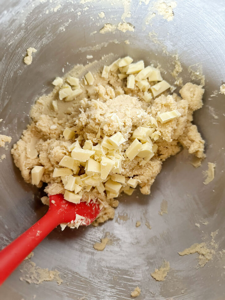 Adding white chocolate to batter.