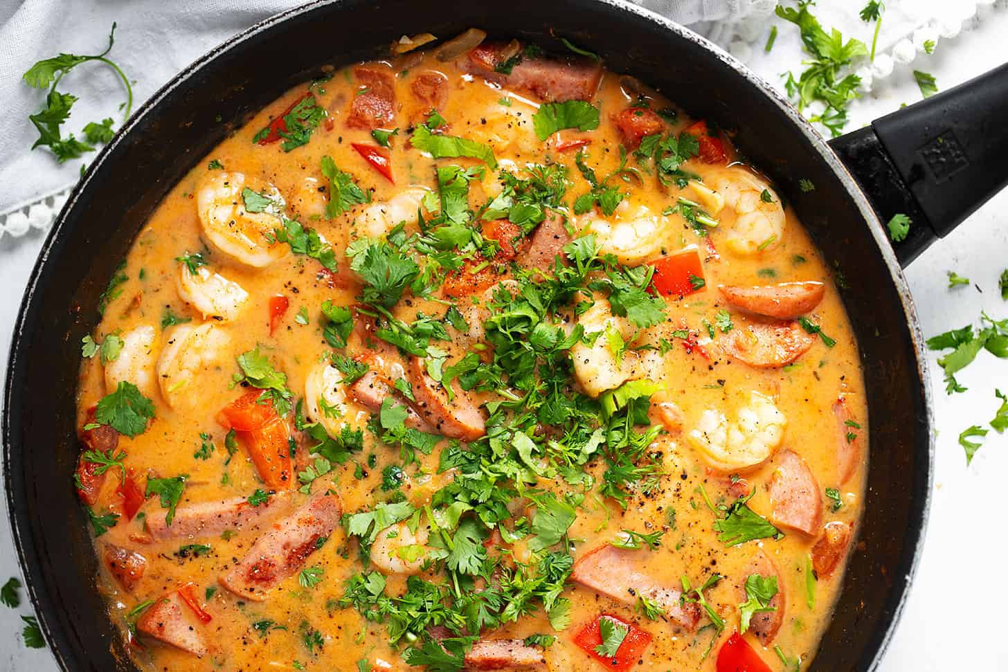 Cajun shrimp and sausage in skillet.