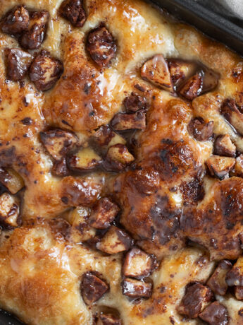 Apple fritter focaccia in baking pan.