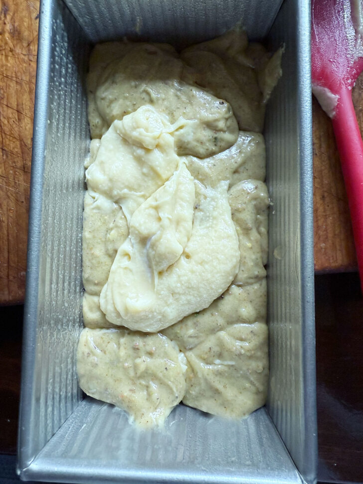 Adding pistachio batter and remaining loaf batter to loaf pan.