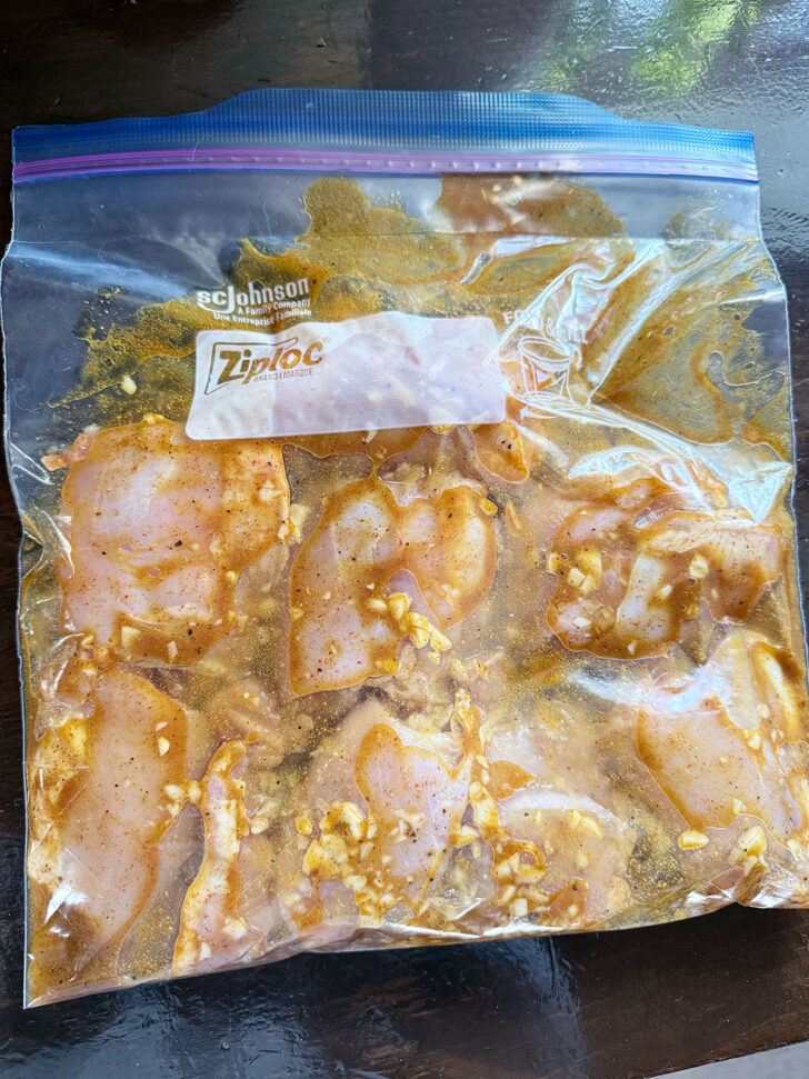 Chicken with shawarma marinade in a zipper bag.