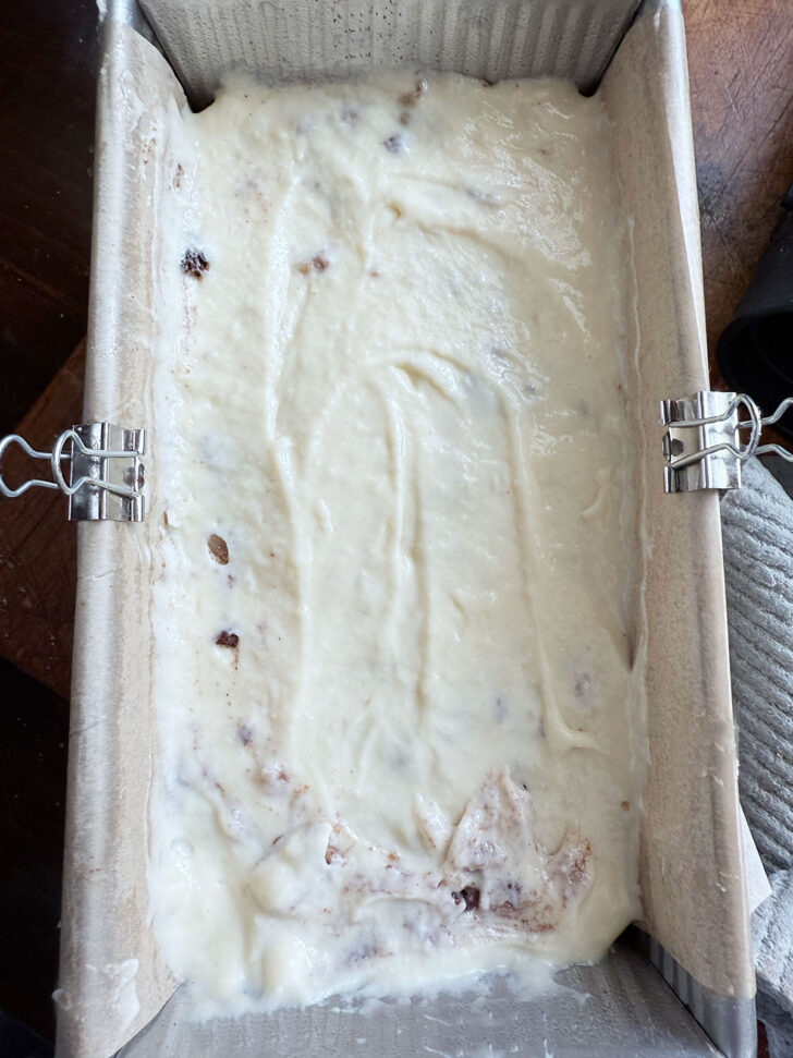 Finishing with the last layer of batter in the loaf pan.