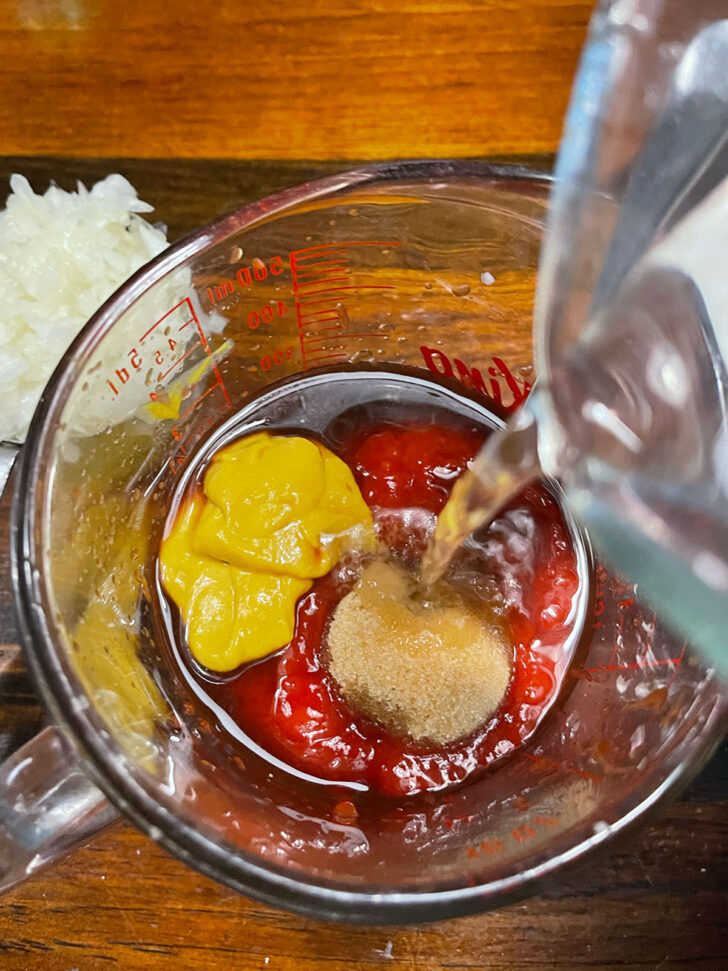 Mixing the sauce ingredients in a measuring cup.
