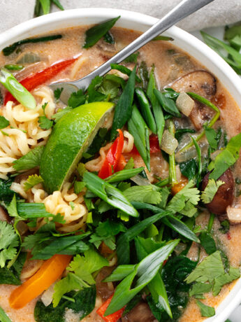 Spicy coconut ramen in bowls with a fork.