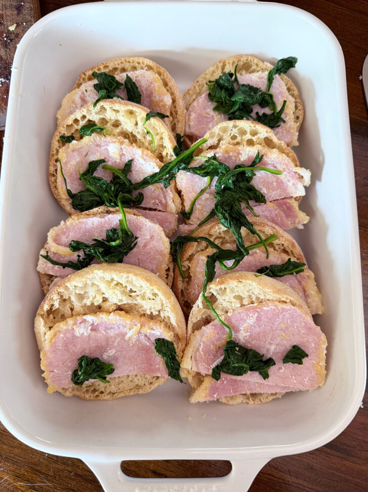 English muffins topped with back bacon and spinach.