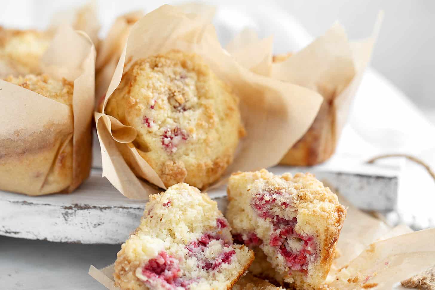 Raspberry lemon muffins on serving board.