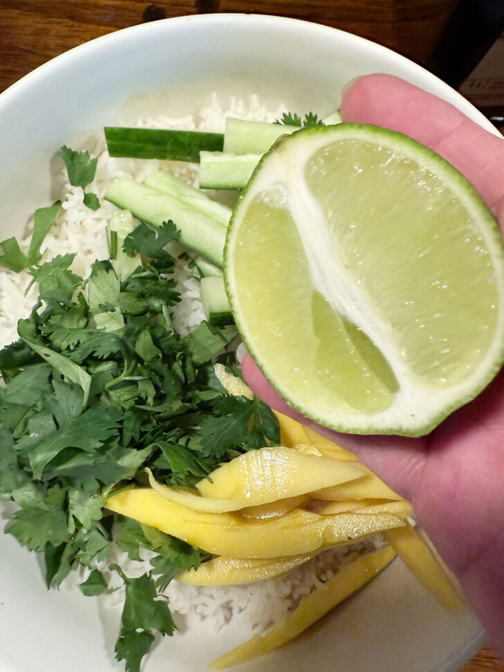 Adding lime juice to rice salad.