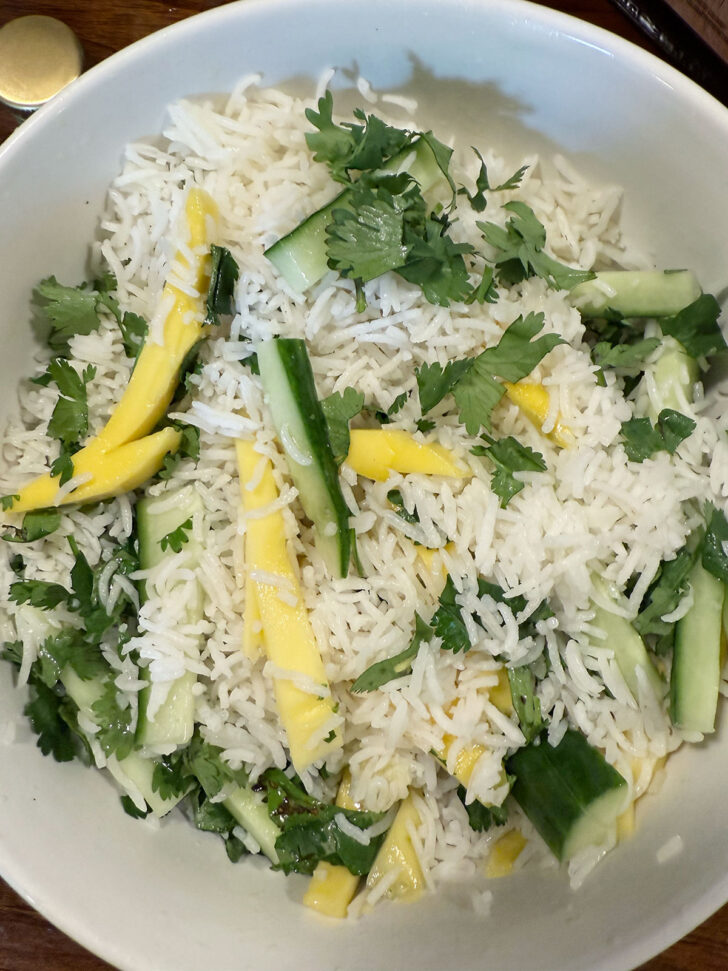 Rice salad tossed together in a bowl.
