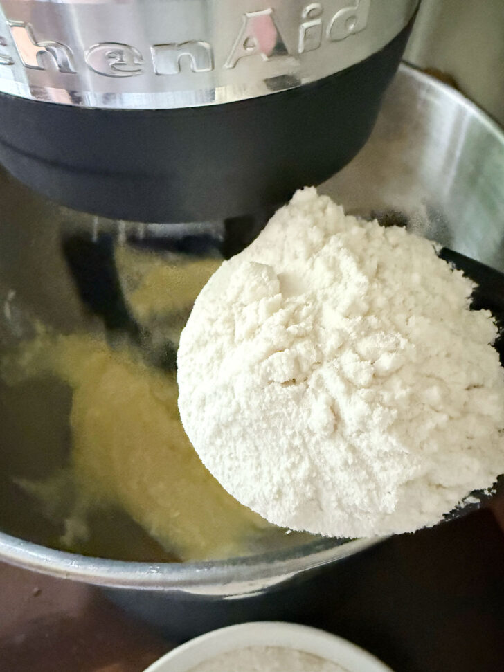 Adding the flour to the mixing bowl.