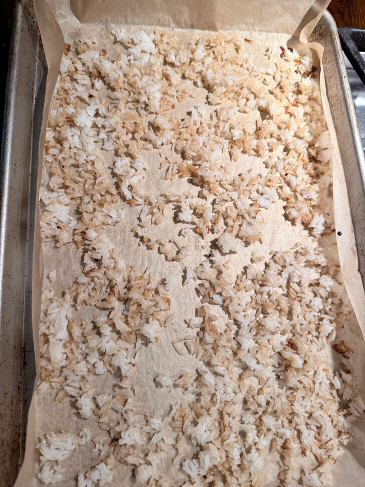 Crispy rice on parchment-lined baking sheet.