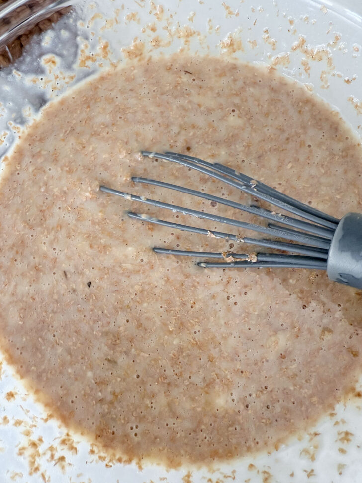 Wet ingredients whisked together in a bowl.