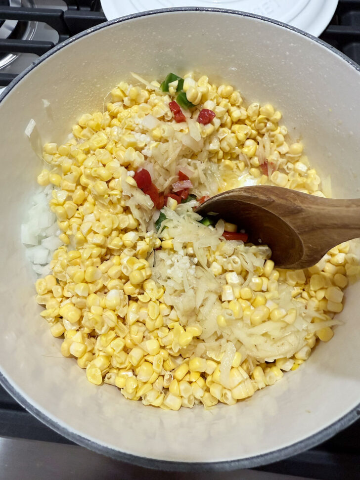 Creamy corn chowder ingredients in a soup pot.