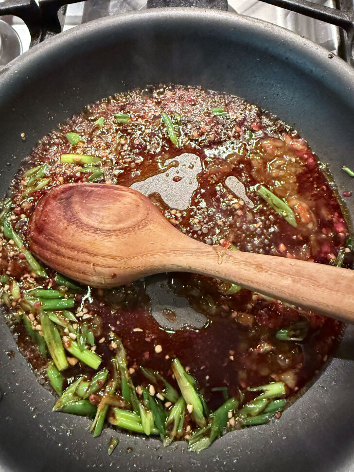 Cooking the spicy orange sauce down a bit.