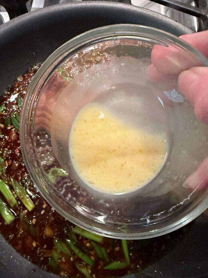 Adding thickener to the sauce.