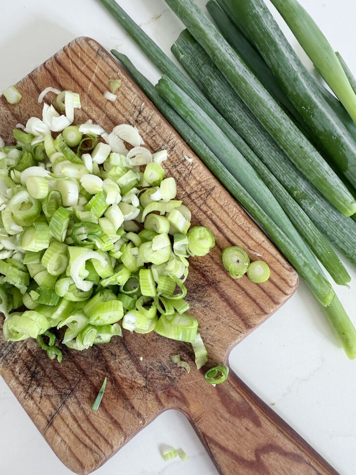 Chopping green onions for adding to the cornbread.