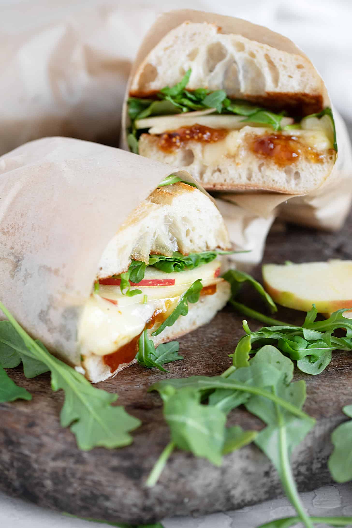 Apple Brie sandwich on cutting board.