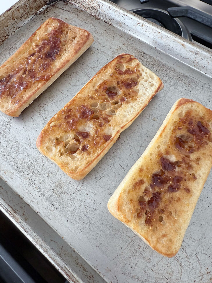 Fig jam spread on the toasted ciabatta buns.
