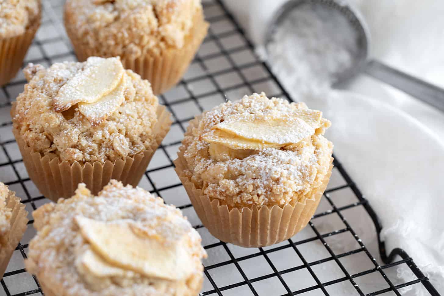 Apple crisp muffins on cooling rack.