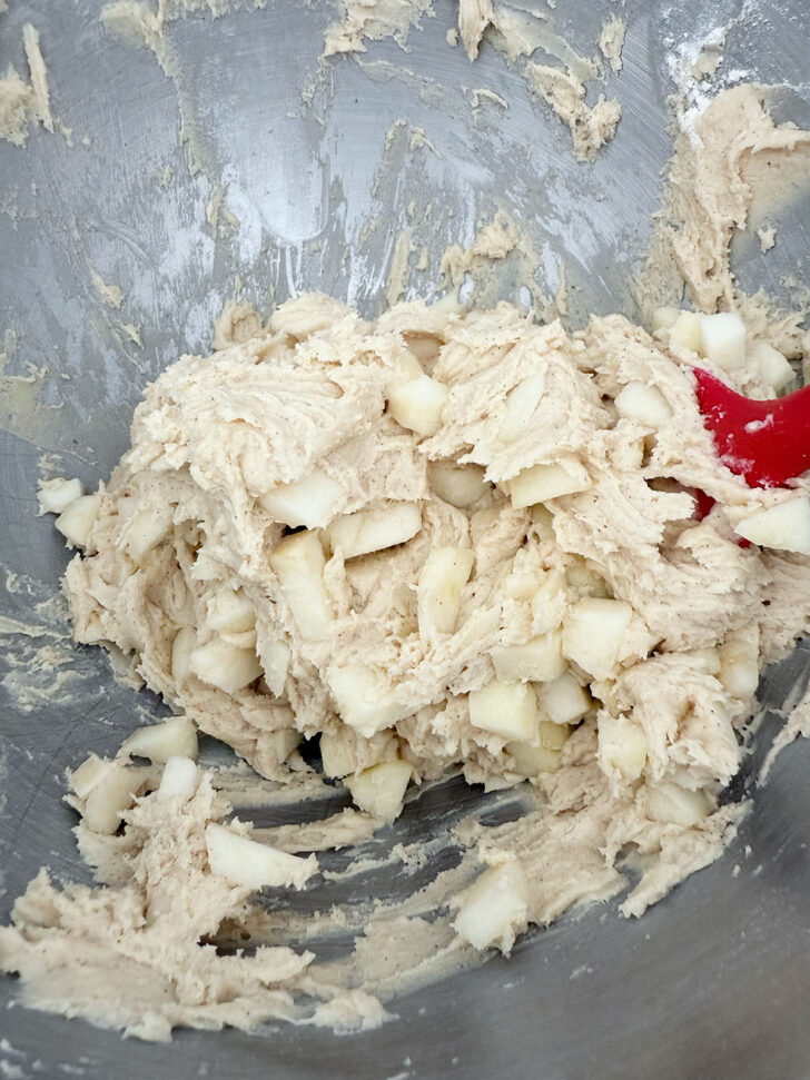 Adding the diced apple to the muffin batter.