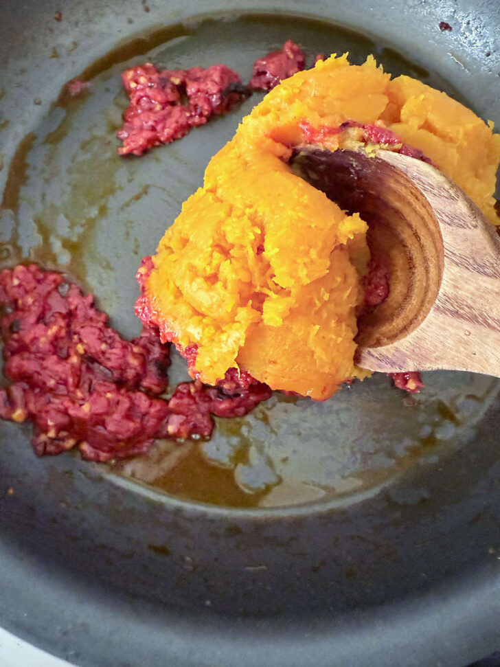 Adding the butternut squash to the skillet.