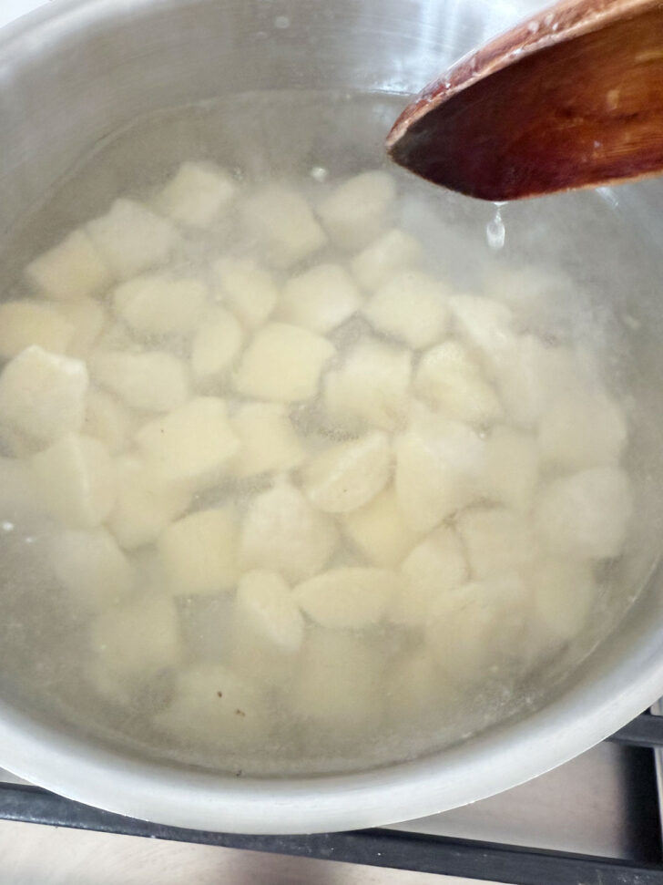 Gnocchi added to boiling water to cook.