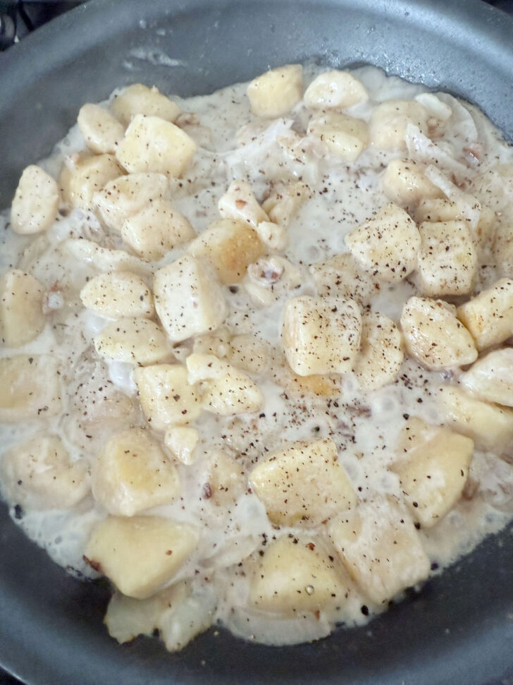 Cream and seasoning added to the skillet.