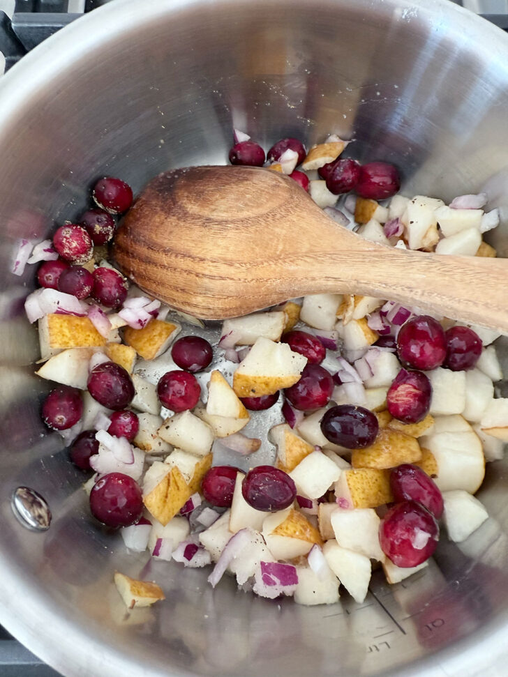 Pear and cranberry chutney ingredients in a saucepan.