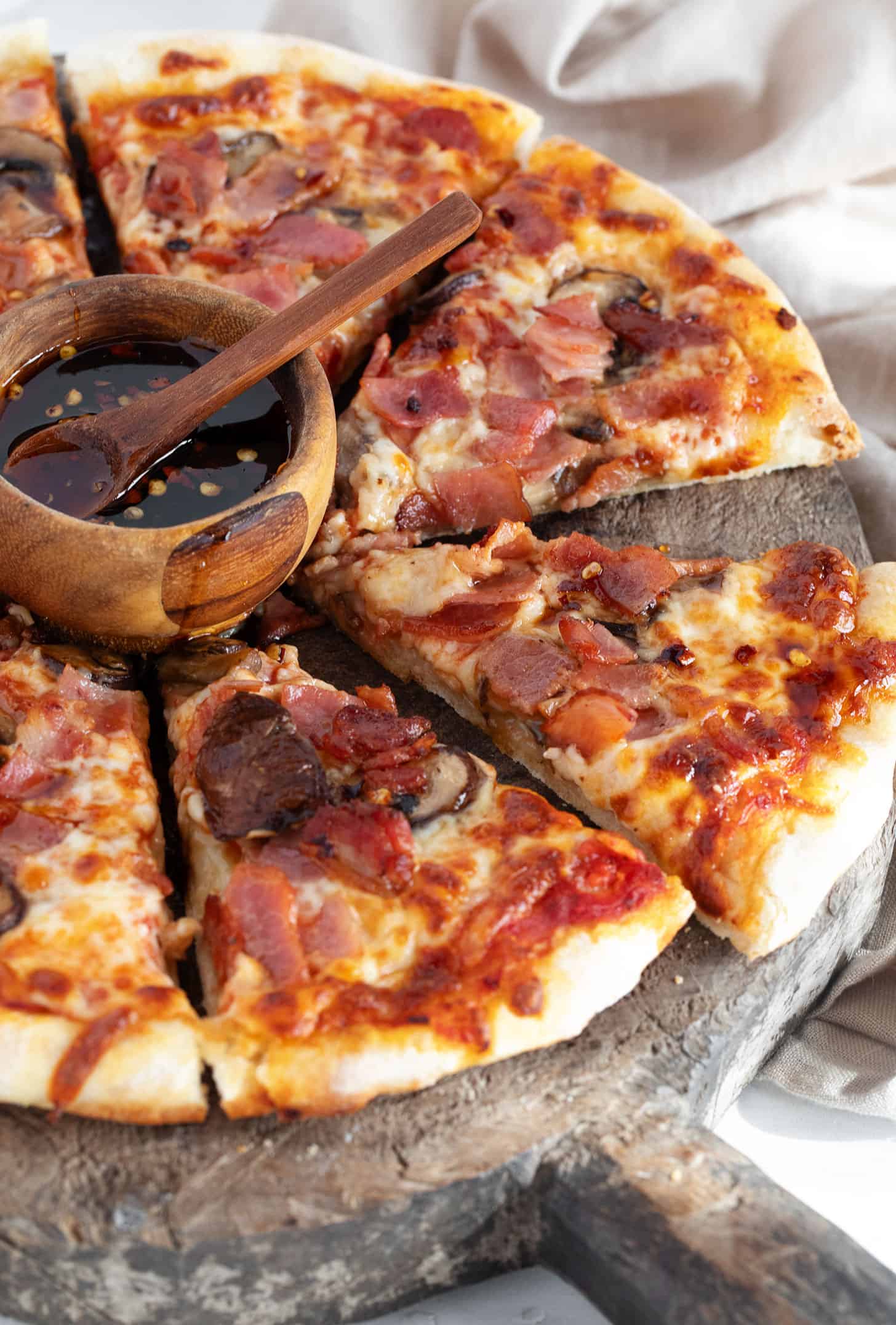 Classic Canadian pizza sliced ​​on a serving board.