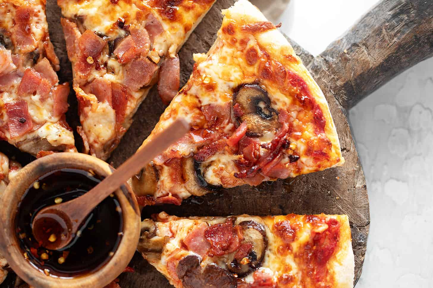 Classic Canadian pizza sliced ​​on a serving board.