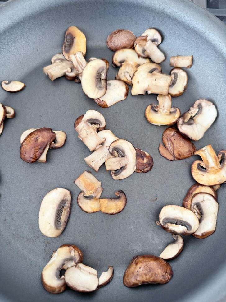 Raw mushrooms in a skillet.