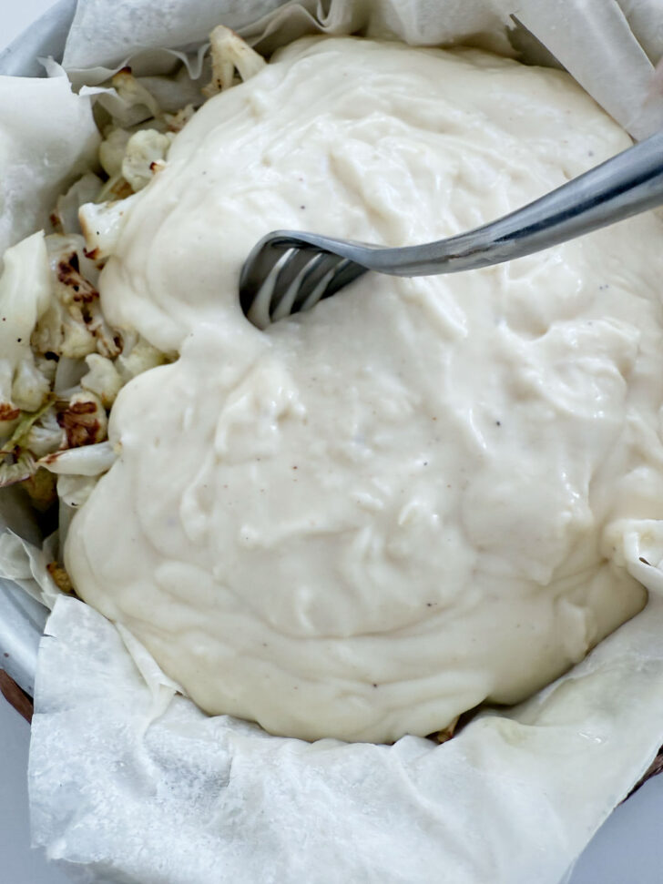 Cheese sauce poured over the roasted cauliflower.