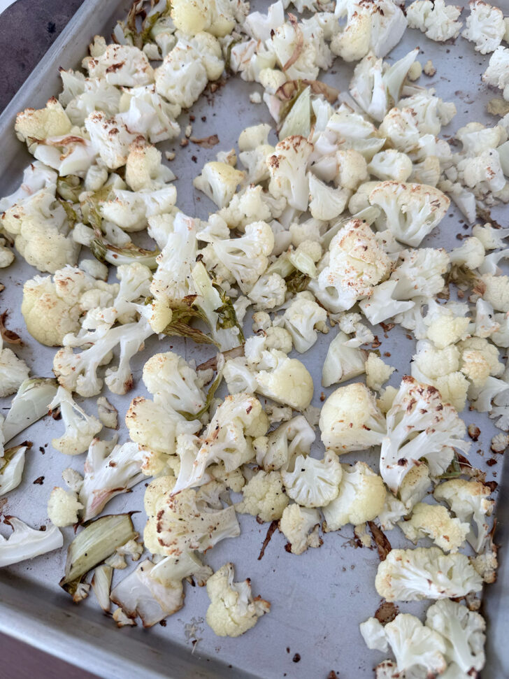 Cauliflower after roasting on a baking sheet.