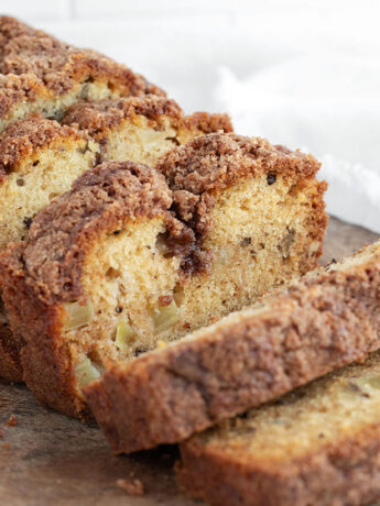 Dutch apple loaf sliced on a cutting board.