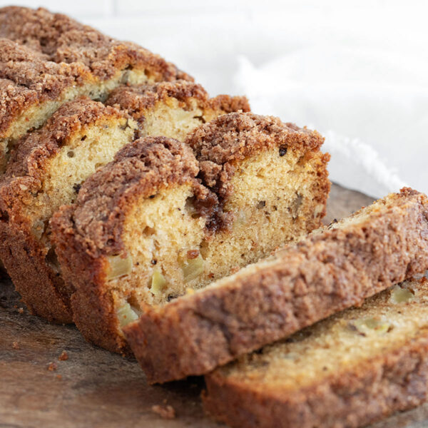 Dutch apple loaf sliced on a cutting board.