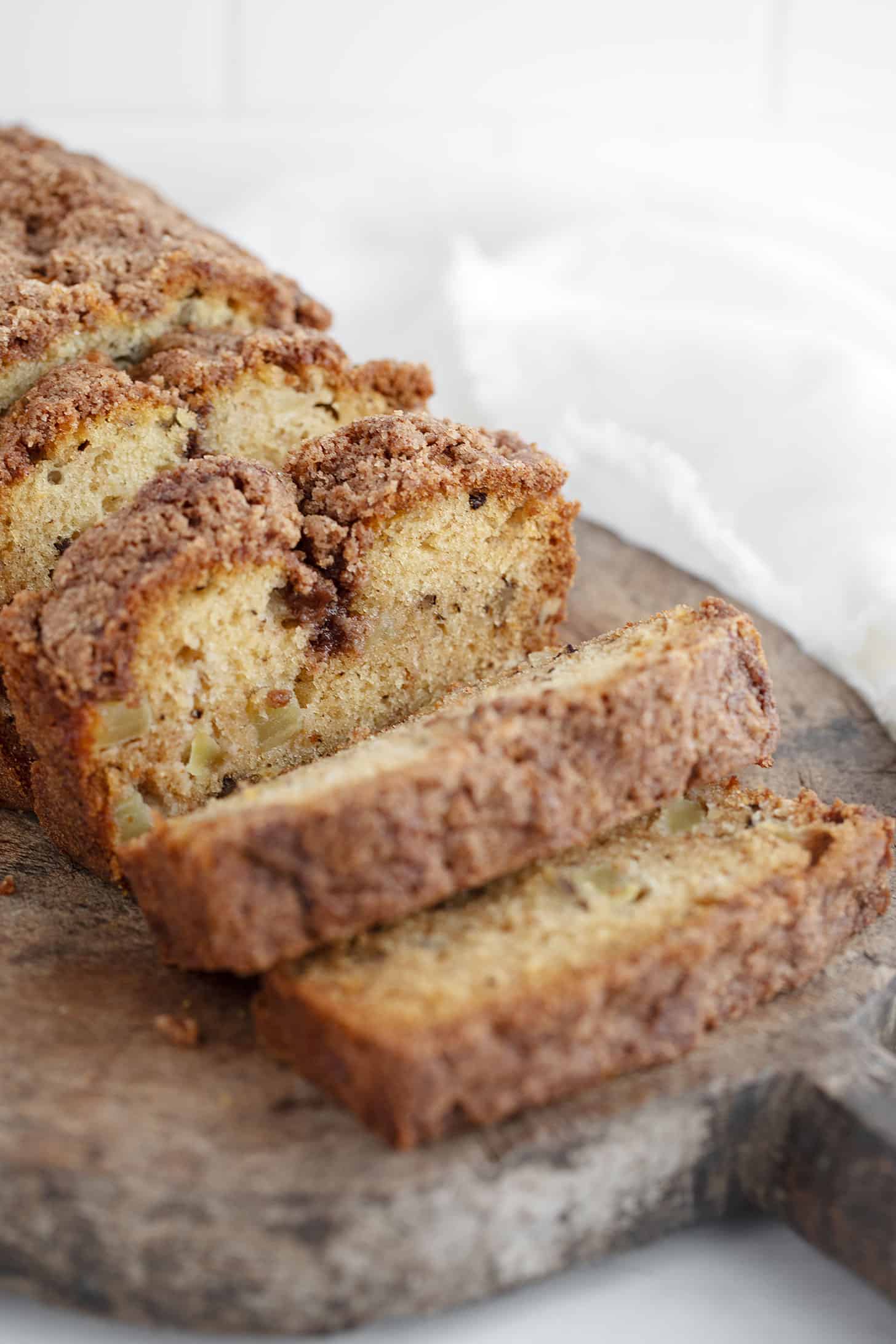 Dutch apple loaf sliced on a cutting board.