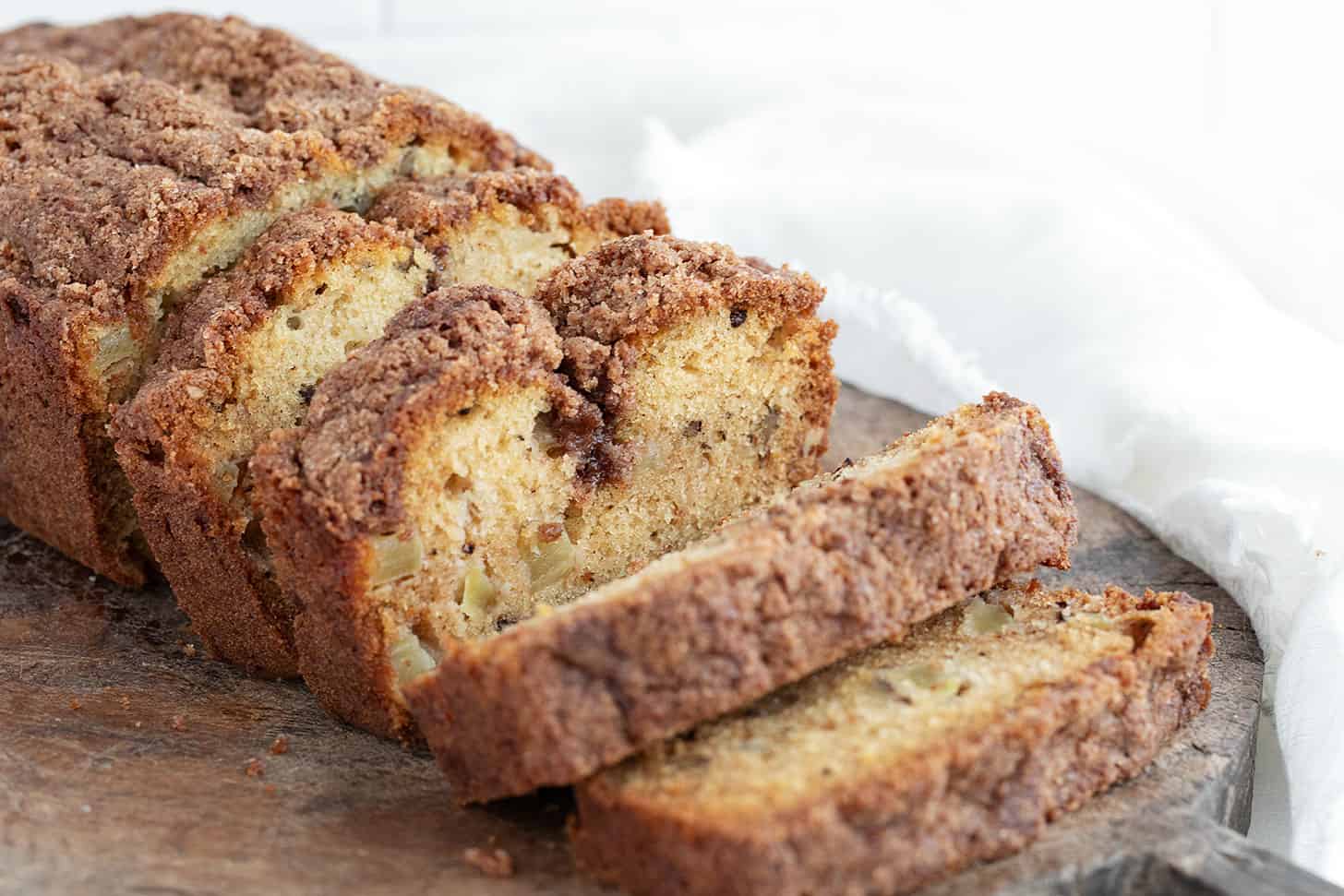 Dutch apple loaf sliced on a cutting board.