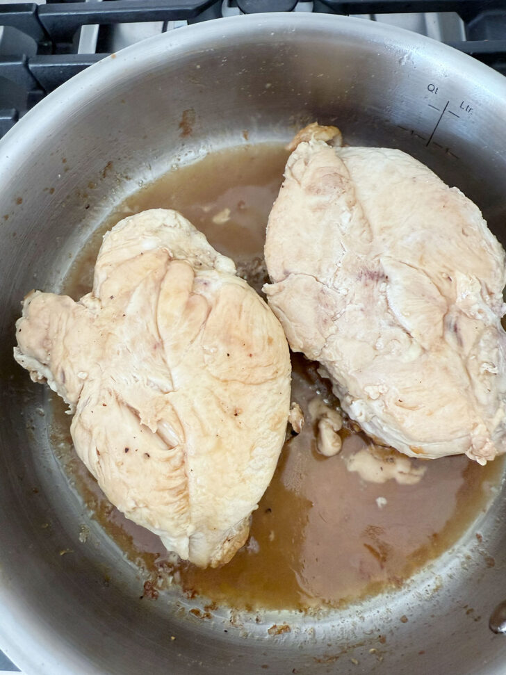 Glazing the chicken breasts skin side down.