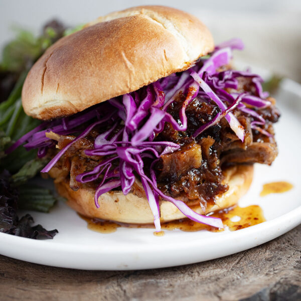 Maple mustard pulled pork on a bun with shredded cabbage.