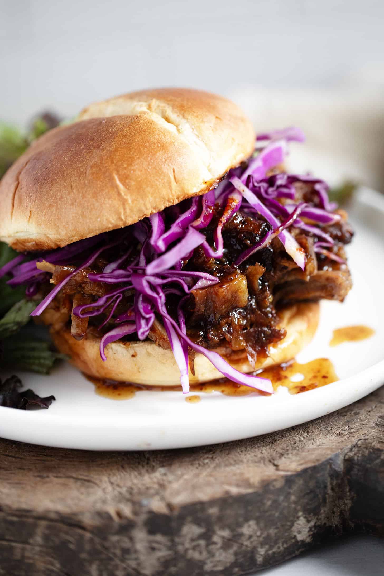 Mustard and maple put the pork on a bun and serve with red cabbage.