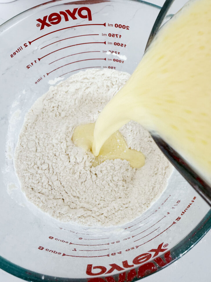 Adding the wet ingredients to the dry ingredients for the waffles.