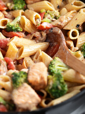 Cajun salmon pasta in a cast-iron skillet.